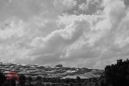 Sun breaking through over houses after the storm